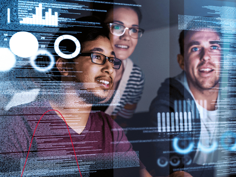 Three professionals look at code displayed on transparent futuristic screen